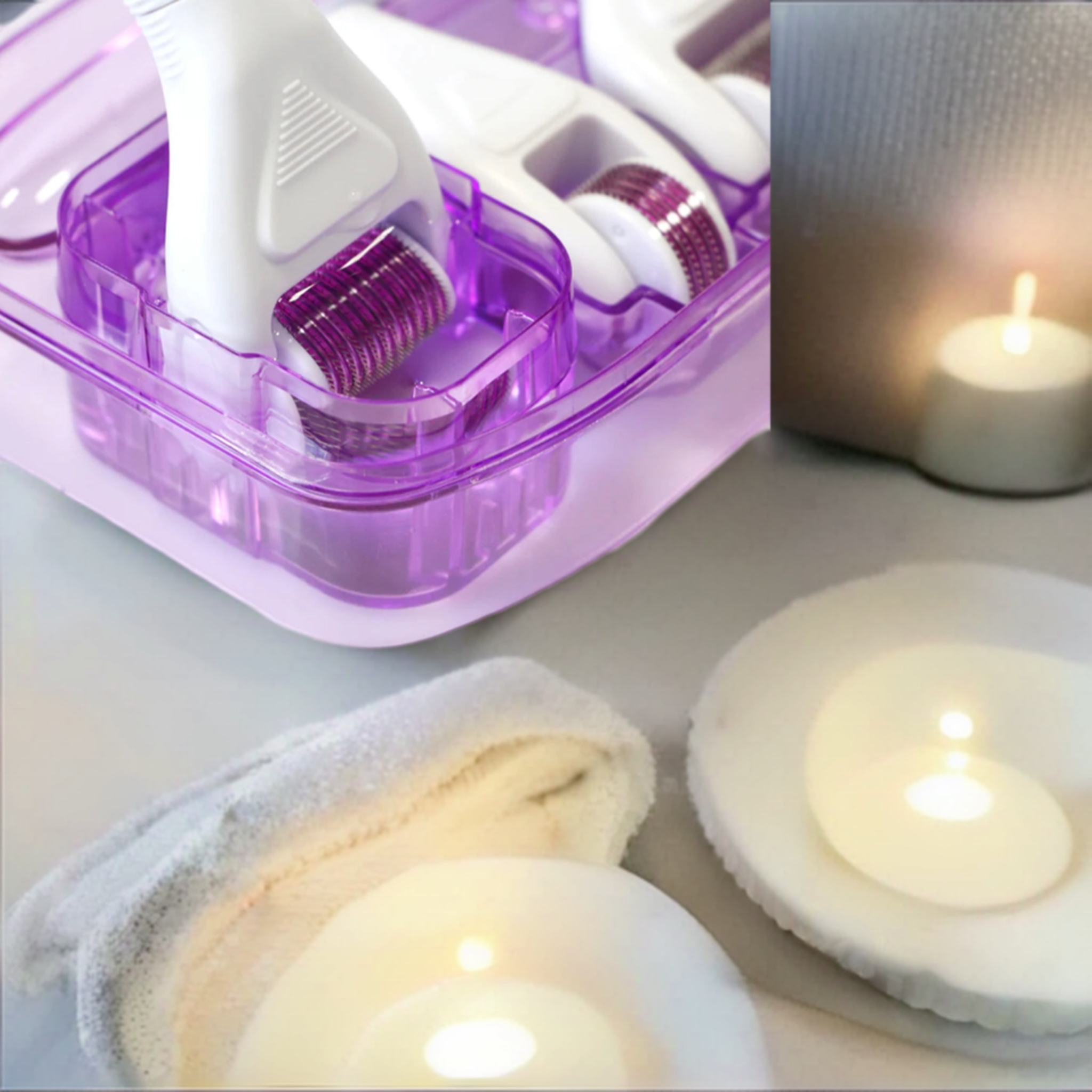 Close-up of 6 In 1 Derma Roller System next to candles on an elegant table.